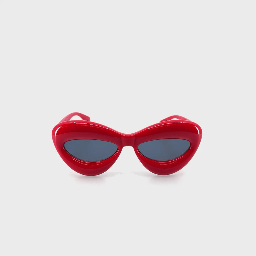 Pufi, UFO szerű, piros színű műanyag szemüveg.